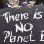 protesters hold sign there is no planet B