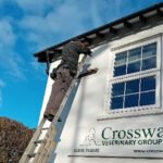 man up ladder installing swift box