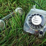 photo of old telephone in grass