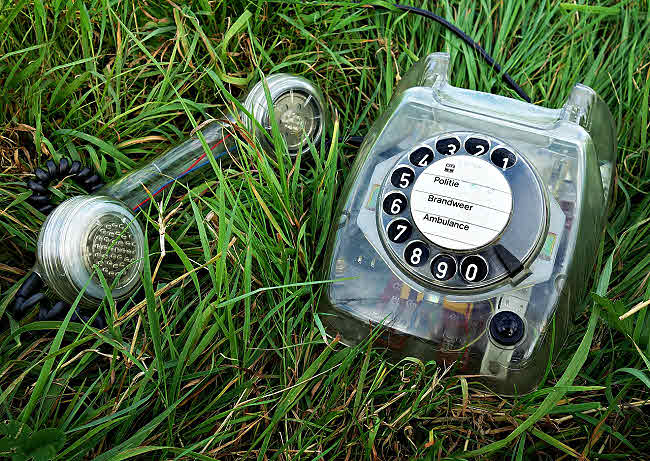 photo of old telephone in grass