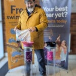 Photo of man recycling batteries