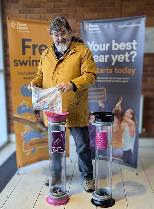 Photo of man recycling batteries
