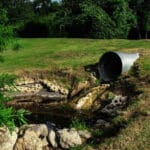 Sewage pipe polluting water course