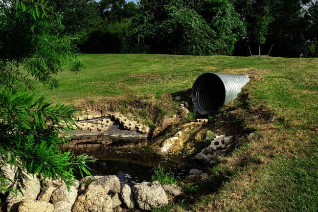 Sewage pipe polluting water course