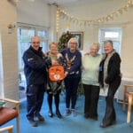 Storrington Warden Chris Poore presenting the defibrillator to the Hannover Walk Retirement Complex residents