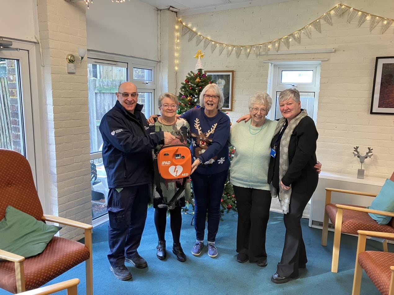 Storrington Warden Chris Poore presenting the defibrillator to the Hannover Walk Retirement Complex residents